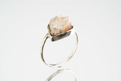 Side view of handmade Sunstone ring showing the raised golden feldspar stone and sturdy sterling silver band.