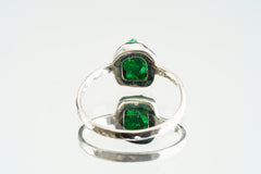 Back view of handmade sterling silver Emerald ring showing the circular band shape and raised green gemstone setting.