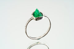 Front view of natural Emerald ring with vivid green beryl colour, handmade sterling silver setting, and solid band.