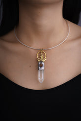 Raft Parable Carnelian Clear Quartz talisman pendant shown worn on the chest with sterling silver and warm crystal detail.