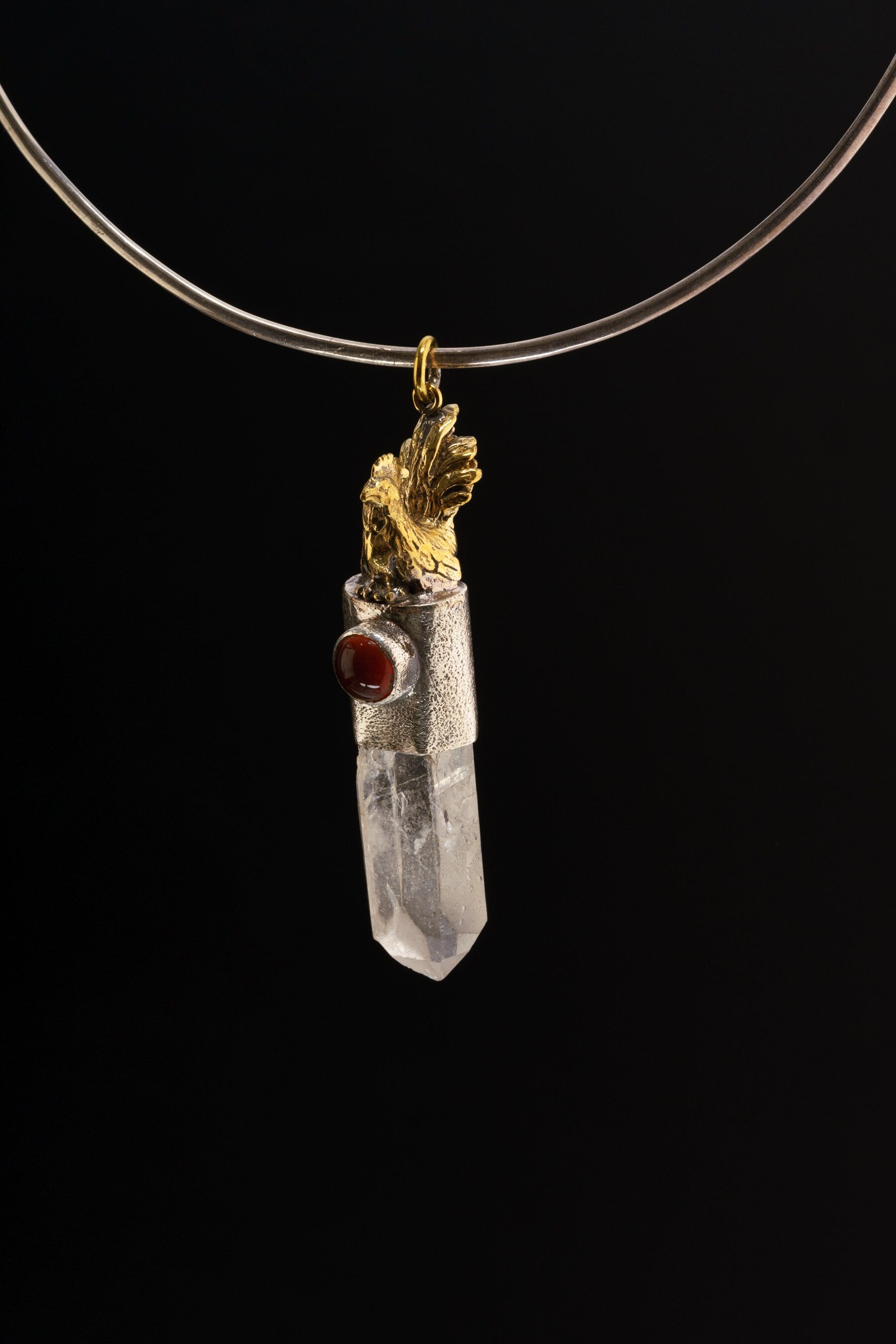 Rooster Carnelian Clear Quartz talisman pendant shown on a black necklace, with symbolic metalwork and clear crystal point.