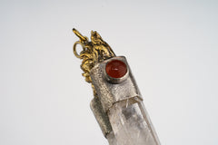 Close-up of Rooster Carnelian talisman pendant with handmade metal detail.