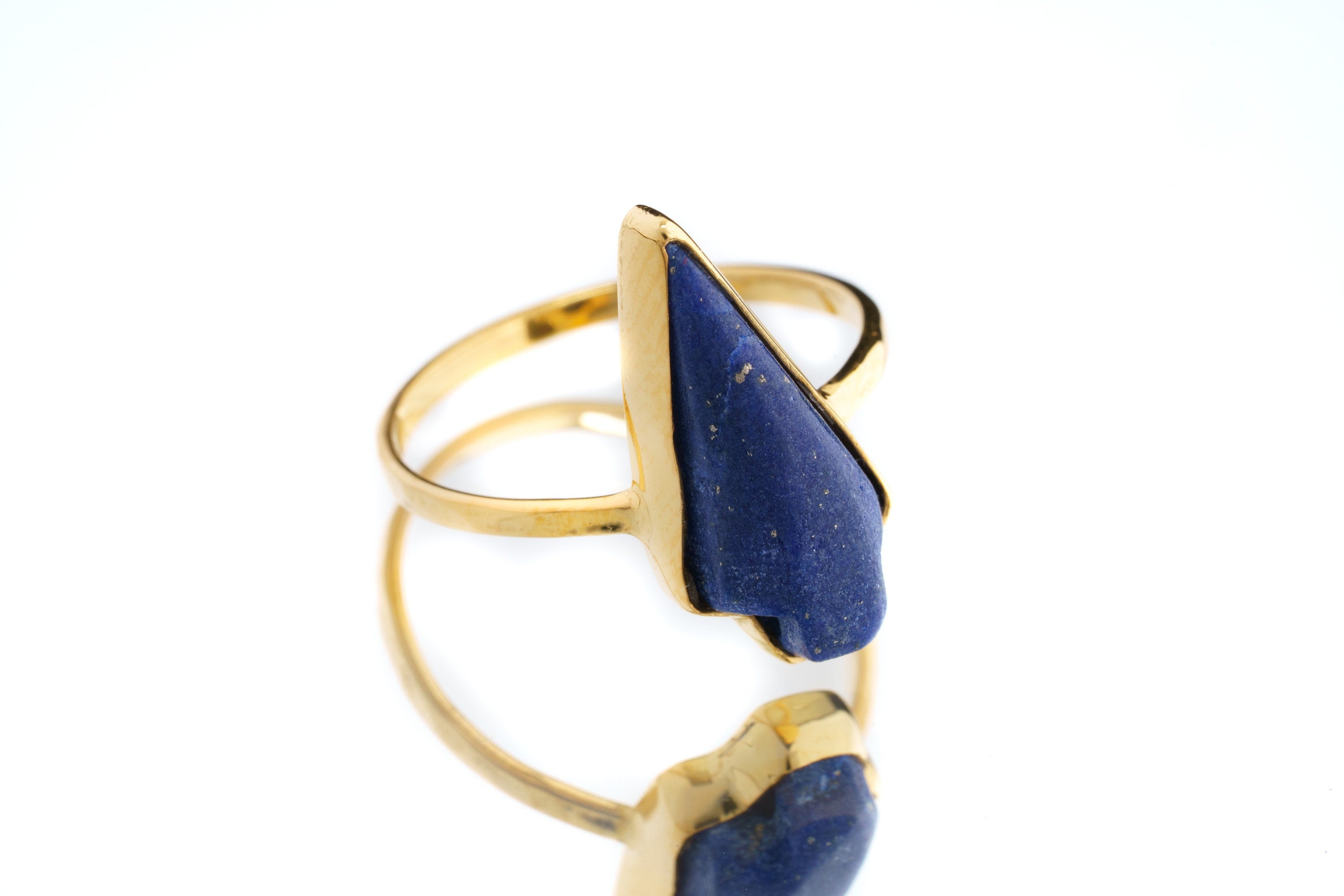 Lapis Lazuli Gold Plated Silver Ring shown on white background with deep blue stone and sculptural gold plated band.