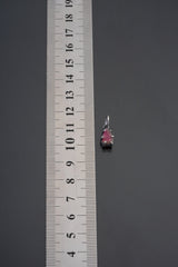 Watermelon Tourmaline pendant shown beside ruler for scale 1.5cm with pink-green crystal in oxidized silver claw setting.