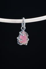 Watermelon Tourmaline pendant on white background showing handmade oxidized silver claw frame and raw crystal detail.