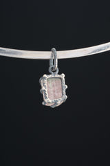 Watermelon Tourmaline Claw Pendant shown worn on black background with handmade oxidized sterling silver setting.