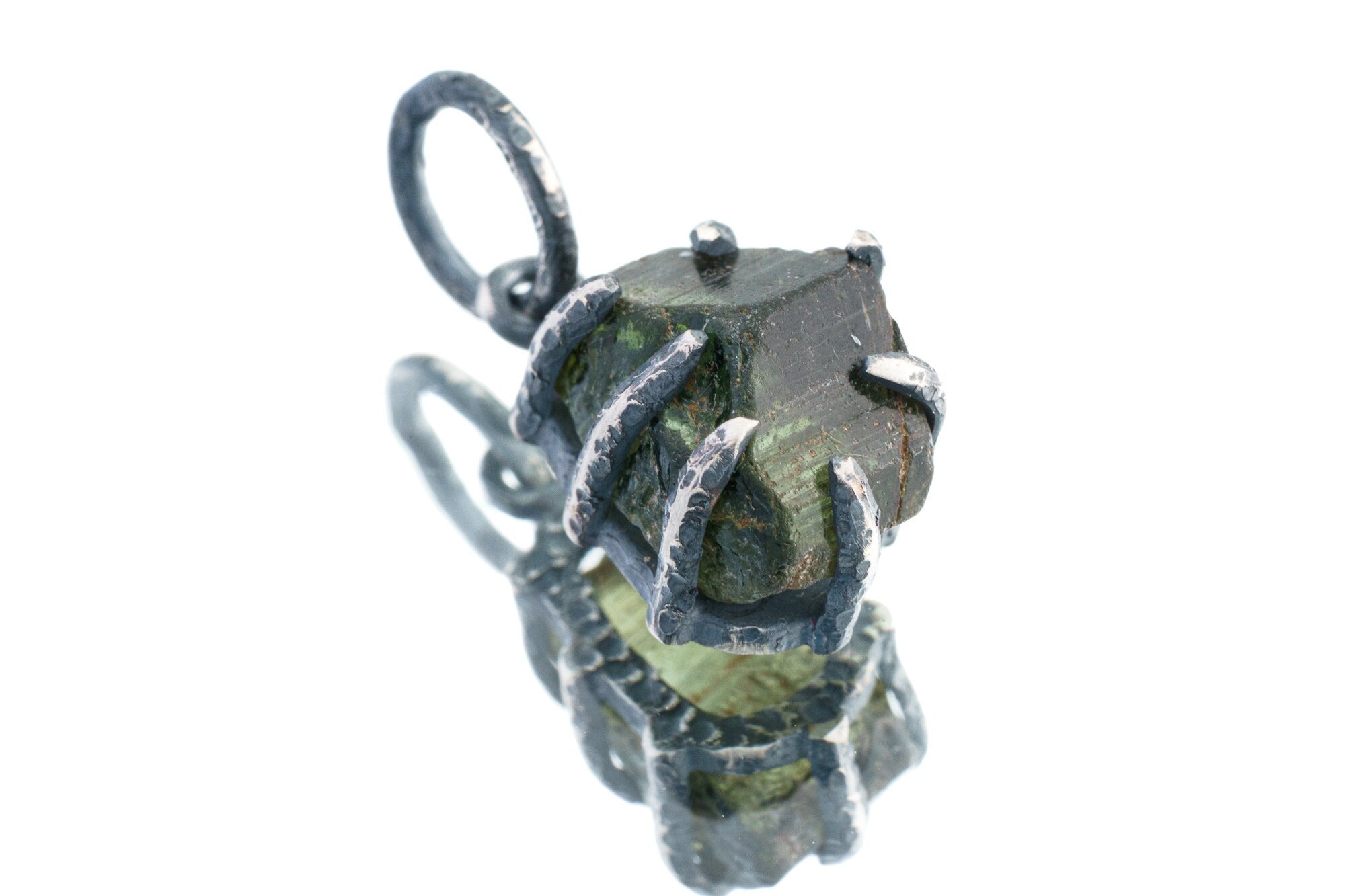 Green Tourmaline Claw Pendant on white background with oxidized sterling silver and natural deep green crystal.