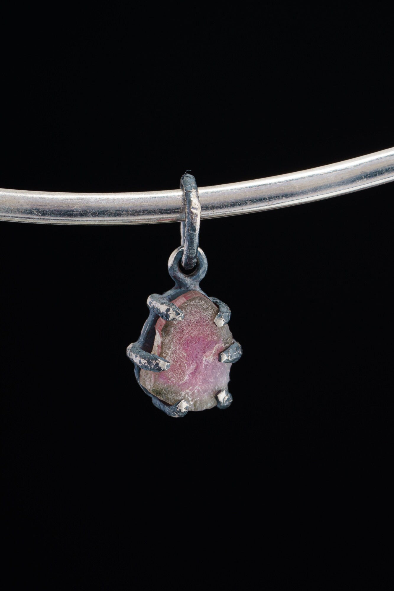 Watermelon Tourmaline Claw Pendant on white background with oxidized sterling silver and natural pink-green crystal.