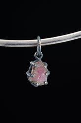 Watermelon Tourmaline Claw Pendant on white background with oxidized sterling silver and natural pink-green crystal.