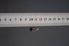 Pink Tourmaline Rubellite pendant shown beside ruler for scale 1.5cm with rose-pink crystal in oxidized silver claw setting.