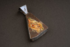Ammolite Ammonite pendant shown from the back, with open-back sterling silver bezel and visible fossil body.