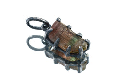 Watermelon Tourmaline pendant on white background showing handmade oxidized silver multi-prong claw frame.