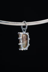 Watermelon Tourmaline Claw Pendant shown worn on a black background necklace with compact oxidized silver setting.