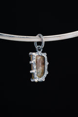Watermelon Tourmaline Claw Pendant shown worn on a black background necklace with compact oxidized silver setting.