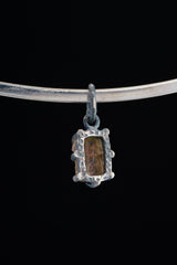 Watermelon Tourmaline Claw Pendant shown worn on a silver choker with compact oxidized silver setting.