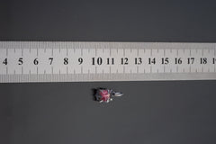Pink Tourmaline Rubellite pendant shown beside ruler for scale 1.5cm with rose-pink crystal in oxidized silver claw setting.