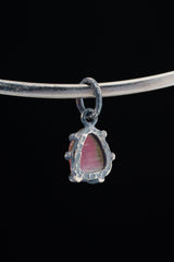 Watermelon Tourmaline Claw Pendant shown worn on black background with handmade oxidized sterling silver setting.
