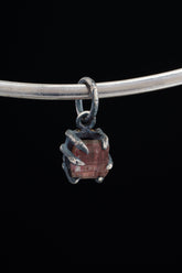 Pink Tourmaline Rubellite Claw Pendant on black background with oxidized sterling silver and natural rose-pink crystal.