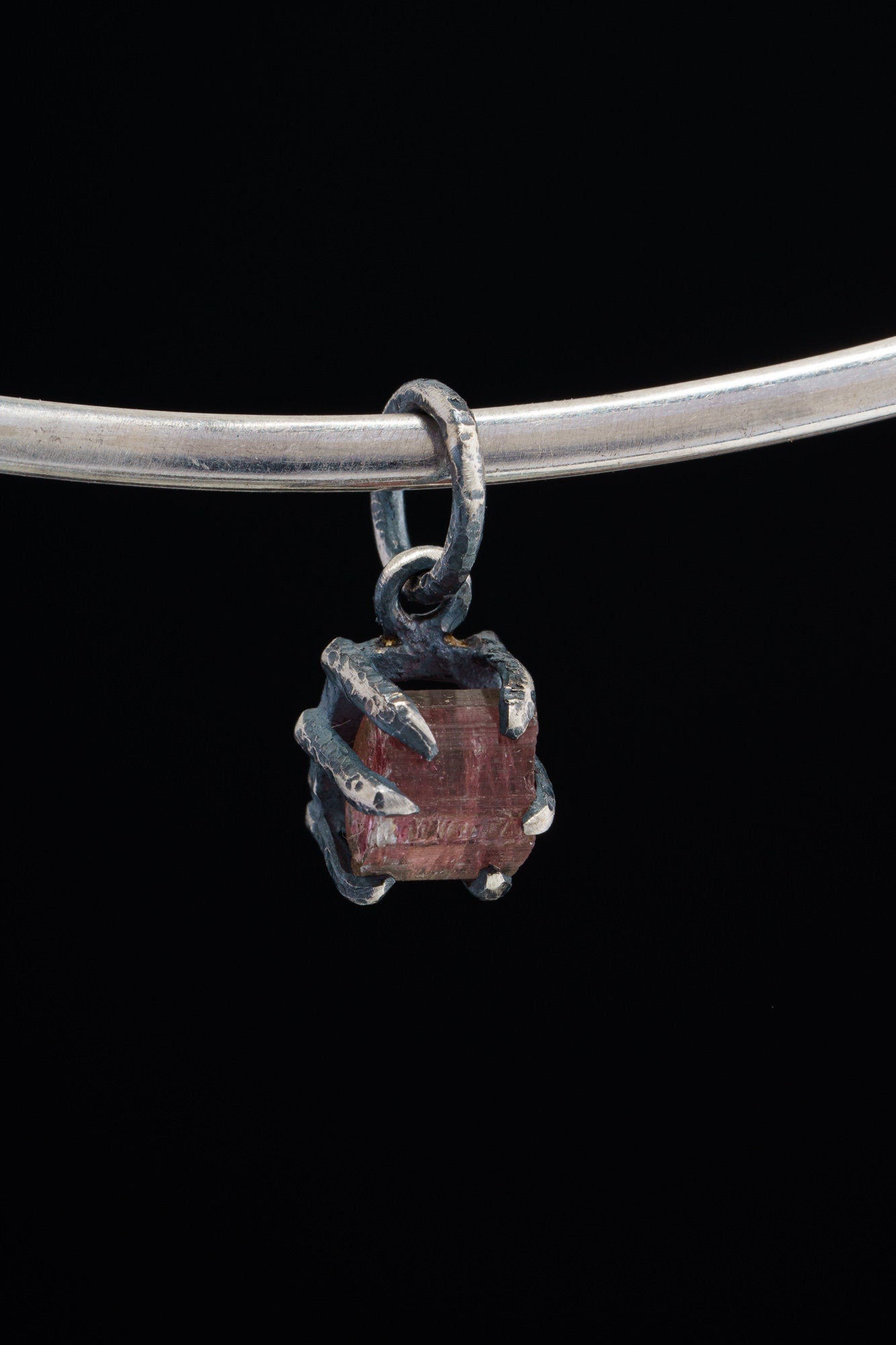 Pink Tourmaline Rubellite Claw Pendant on black background with oxidized sterling silver and natural rose-pink crystal.