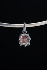 Pink Tourmaline Rubellite Claw Pendant on black background with handmade oxidized sterling silver frame.
