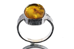 Front view of Amber oxidized silver ring showing warm golden resin stone and rugged hammered sterling silver profile.