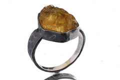 Citrine oxidized silver ring shown from the side, with warm honey-coloured stone and hammered handmade texture.