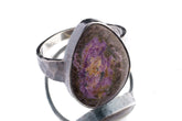 Sugilite ring in oxidized 925 sterling silver with hammered texture, open-back bezel, and deep purple gemstone.