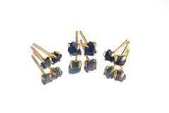 Australian creek tumbled Sapphire stud earrings in gold-plated sterling silver shown on white background.