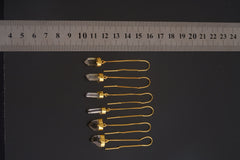 Himalayan Quartz gold-plated dangle earring collection shown beside a ruler with clear crystal points.