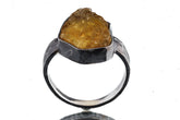 Citrine ring in oxidized 925 sterling silver with hammered texture, open-back bezel, and warm golden quartz stone.