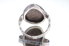 Back view of Sugilite ring showing open-back bezel construction and hammered oxidized sterling silver band.