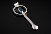 Blue Apatite sterling silver ritual spoon shown on dark background with hand-hammered silver and blue gemstone setting.
