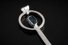 Close-up of Blue Apatite ritual spoon showing hammered sterling silver setting and vivid blue gemstone.