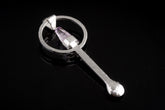 Vera Cruz Amethyst sterling silver hammered spoon pendant shown on dark background with purple crystal setting.