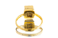 Pyrite ring shown worn outdoors on a hand, with gold-plated 925 silver band and metallic mineral stone.