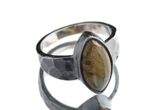 Labradorite ring in oxidized 925 sterling silver with hammered texture, open-back bezel, and shifting blue-green flash.