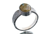 Labradorite ring in oxidized 925 sterling silver with hammered texture, open-back bezel, and shifting golden-green flash.