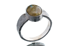 Labradorite ring in oxidized 925 sterling silver with hammered texture, open-back bezel, and shifting golden-green flash.