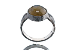 Front view of Labradorite statement ring showing hammered oxidized silver band and natural flashing gemstone centre.