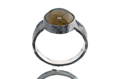 Front view of Labradorite statement ring showing hammered oxidized silver band and natural flashing gemstone centre.