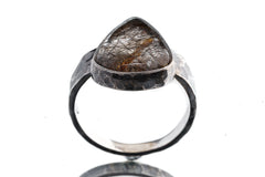 Rutilated Quartz ring shown from the front with visible rutile strands inside the stone and oxidized sterling silver setting.