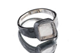 Selenite ring in oxidized 925 sterling silver with hammered texture, open-back bezel, and pale luminous stone.