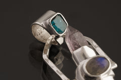 Two Sided Crystal Spinner Pendant shown angled on black background with Aquamarine, Labradorite, Apatite, and polished silver details.