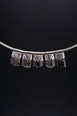 Group of Himalayan Dravite Tourmaline Stack Pendants shown on black background with dark terminated crystals and silver caps.