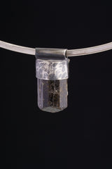 Himalayan Dravite Tourmaline Stack Pendant shown on black background with oxidized 925 silver cap and compact dark crystal body.