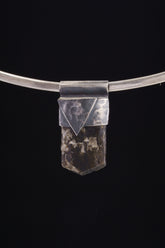 Himalayan Dravite Tourmaline Stack Pendant shown on black background with oxidized sterling silver cap and dark terminated crystal.