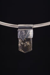 Himalayan Dravite Tourmaline Stack Pendant shown on black background with oxidized sterling silver cap and dark terminated crystal.
