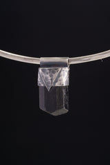 Himalayan Dravite Tourmaline Stack Pendant shown on black background with oxidized sterling silver cap and dark terminated crystal.