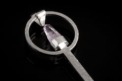 Close-up of Vera Cruz Amethyst spoon pendant showing hammered sterling silver texture and delicate crystal setting.