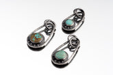 Three Royston Turquoise Cosmic Ray pendants in oxidized 925 sterling silver, showing blue-green stones and celestial ray details.